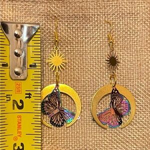 Antique gold colored earrings with iridescent butterflies.